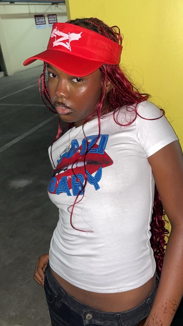 IZI model wearing the Go Izi Baby tee and red visor